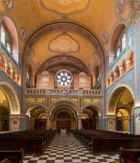 Szeged, Hungary, 14 October, 2022: view of the central nave with wooden pews and the church organ