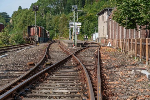 Rail switches run alongside a building between trees, bochum, westphalia, germany