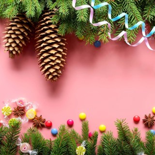 Flat lay design of Christmas greeting card of fir twigs cones, paper streamer, candies and spices