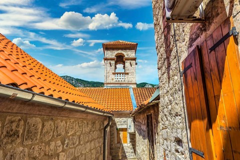 Belltower in the Old Town of Kotor at sunny day