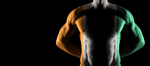 Ivory Coast flag on muscled male torso with abs, black background