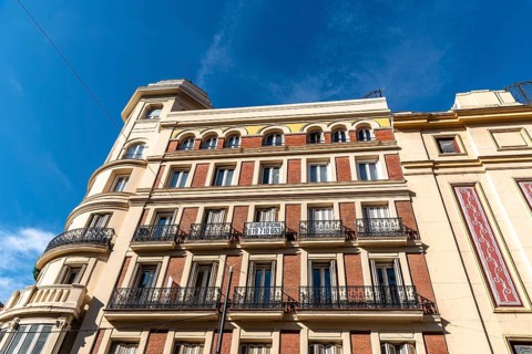 Madrid, Spain, November 1, 2020: Old residential building with iron balconies in the downtown of