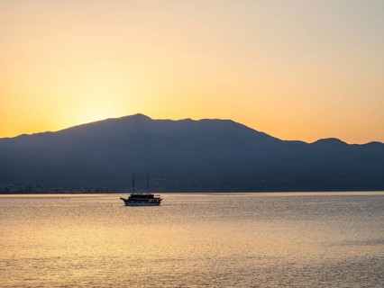 Ship in the morning light in front of sunrise, Peljesac peninsula, view from Korcula, Dalmatia,