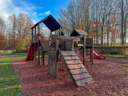 Colorful playground with climbing stairs and slides on yard in the park
