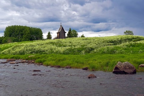 Wooden chapel on the banks of the river Keret. At this point the Keret River flows into the White