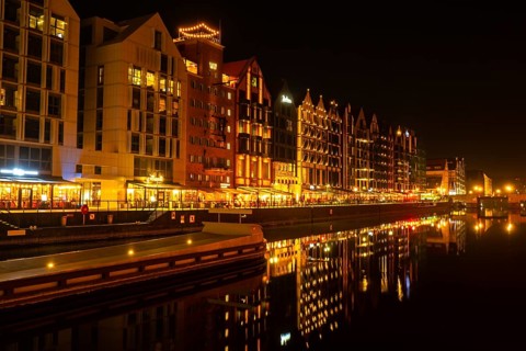 Old town in Gdansk at night. The riverside on Granary Island reflection in Moltawa River Cityscape