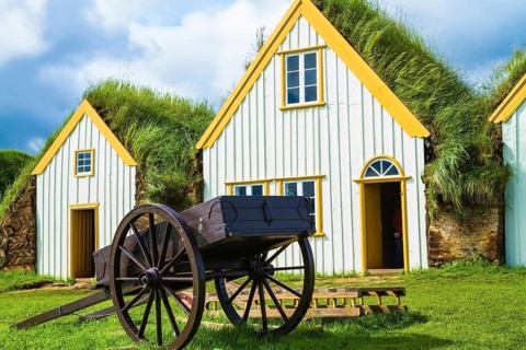 The ancient two-wheeled wooden cart on the front lawn. The village first settlers in Iceland. The