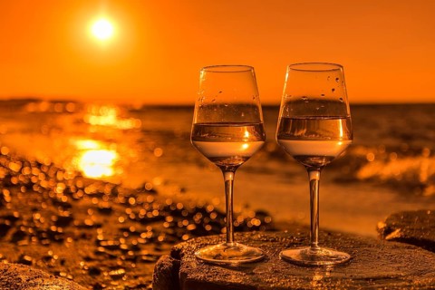 Wine on the baltic sea beach at sunset