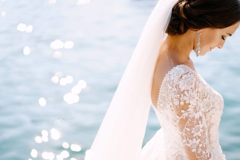 Close-up of the neck and neck of the bride, face profile. Beautiful big earring in ears, shoulder