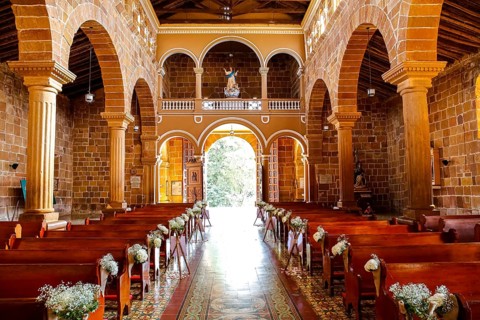 Interior colonial Cathedral of the Immaculate Conception, light is falling through door, Barichara,