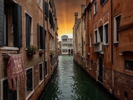 Typical canal of Venice with San Marco flag