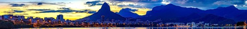 Panoramic image of summer sunset seen from the lagoon Rodrigo de Freitas with the buildings of the