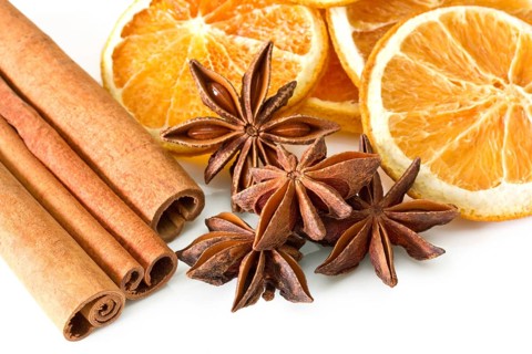 Cinnamon sticks, anise stars and orange slices on white background Cinnamon sticks, anise stars and
