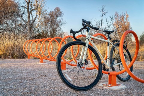 Touring bike parked in colorful helix bike racks along a trail in Fort Collins, Colorado - outdoor