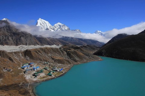 Gokyo, turquoise lake, Ngozumpa Glacier and snow covered mountain Cholatse, Nepal, Asia
