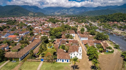 Aerial view to historic town Paraty with tidal river and green mountains in background on a sunny