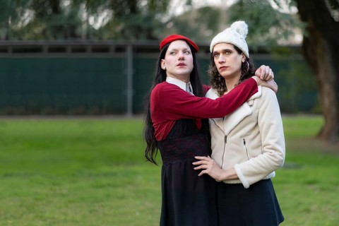 Couple of transgender women posing sensually in a park