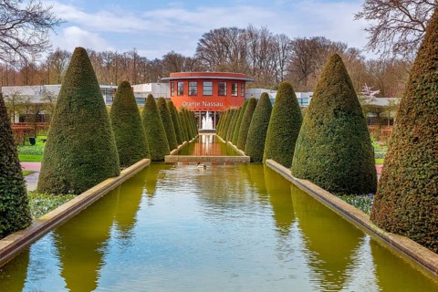 Lisse, Netherlands, April 4, 2016: Spring landscape, touristic park with water fountain and Oranje