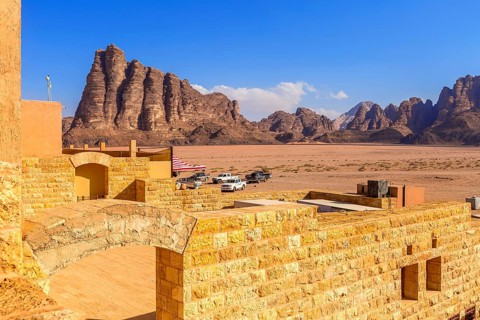 Jordan, Wadi Rum, November 2, 2022: Cars near the entrance to Wadi Rum desert with Seven Pillars of