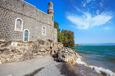Church on the shore of the Sea of Galilee - Tabgha. High waves on the Sea of Galilee. Christian