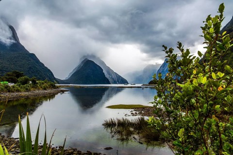 Land of hobbits and goblins. New Zealand. Storm clouds cover the sky over the ocean fjord Milford