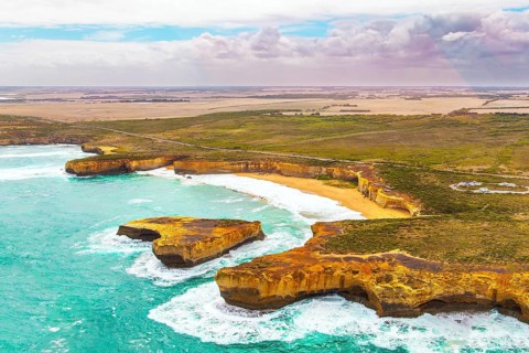 Helicopter flight over the scenic Pacific coastline. The fabulous journey to Australia. Cloudy cool