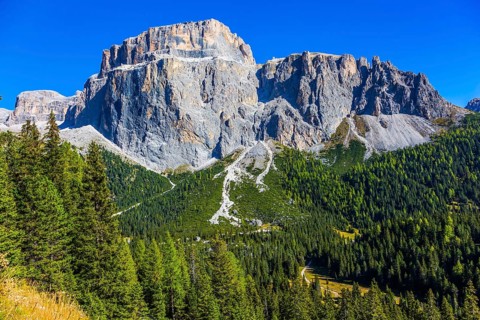 Colossal white and gray rocks against the blue sky. The most beautiful route in the Italian