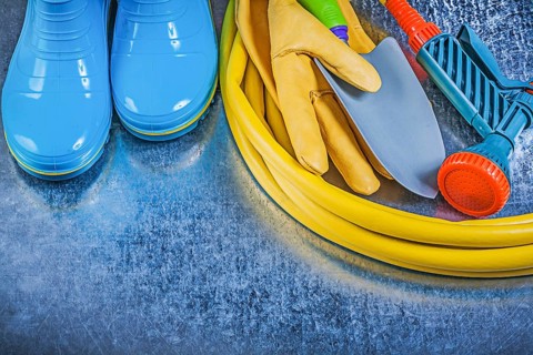 Composition of farming tools on metallic background agriculture concept