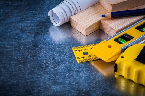Composition of construction working tools on metallic scratched background architecture and