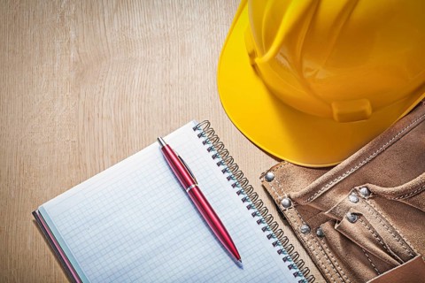 Composition of construction equipment on wooden board