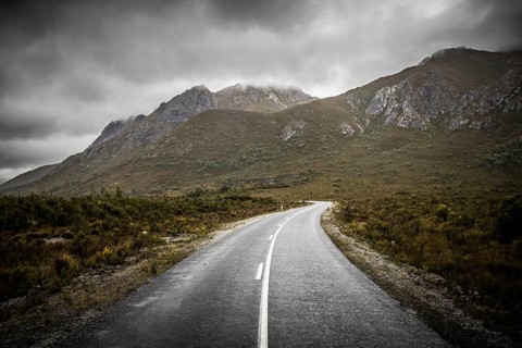 The picturesque Gordon River Rd at the Sentinel range of mountains near Bitumen Bones Sculpture on