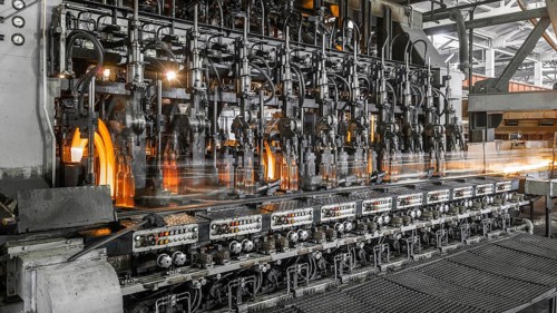 On the conveyor glass bottles are pasteurized with fire. factory shop for the production of glass