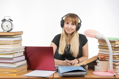 Student with headphones ready to pass the diploma project looked into the frame