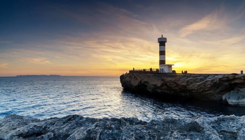 A view of the lighthouse at Colonia Sant Jordi in Mallorca at sunset