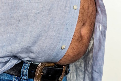 Man with excess weight. Symbolic photo of a beer belly, unsuccessful diets and poor nutrition.