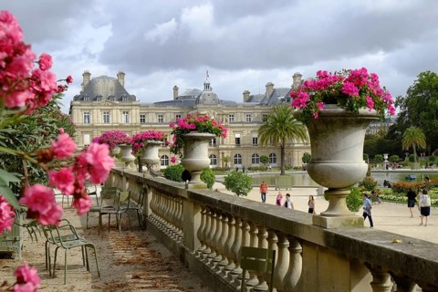 In the Jardin du Luxembourg: Raised terrace with stone balustrade and planted amphorae, well-tended