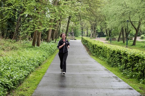 Jette, Brussels Capital Region Belgium, 04 24 2020 Attractive thirty year old woman jogging through