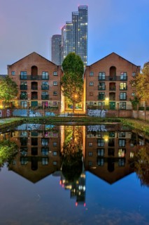 Old buildings and modern skyscrapers at night, seen in Castelfield, Manchester