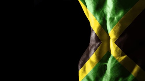 Jamaica flag on abs muscles national sport workout, bodybuilding concept, black background