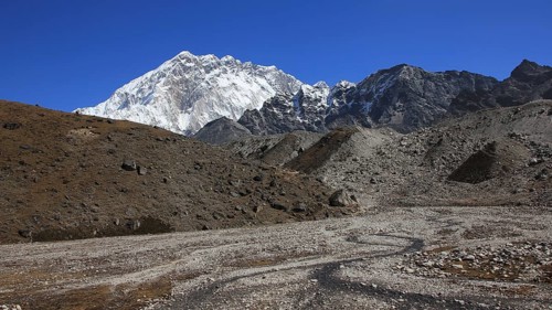 Small creek and azure blue sky over Mount Nuptse, Nepal, Asia