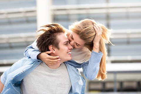 Happy to spending time together. Young beautiful couple outdoor fashion portrait. Attractive boy