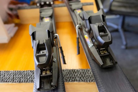Ski center repair service shop, adjust the bindings and boots equipment on the table. Winter rent