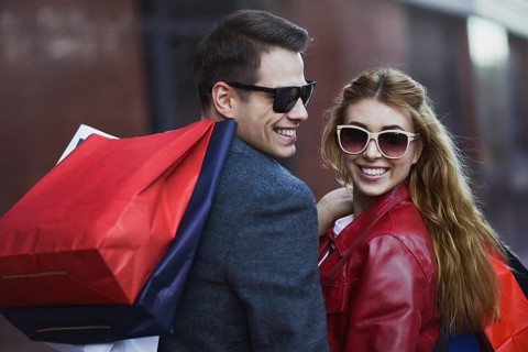 Picture showing young couple shopping in the city. Portrait of a couple with shopping bags in the