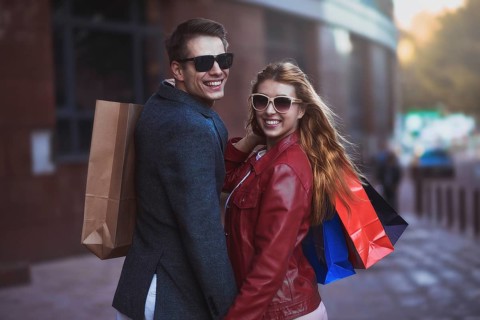 Picture showing young couple shopping in the city. Portrait of a couple with shopping bags in the