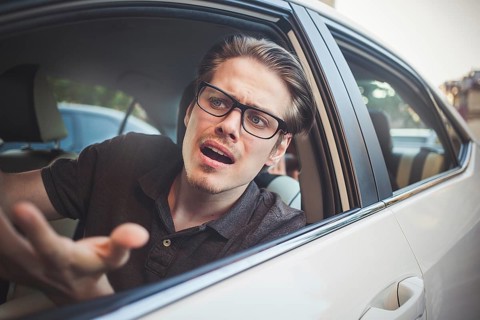 Accident. Young caucasian man driving a car shocked about to have traffic accident