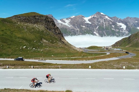 Grossglockner, Austria, August 7, 2017: Cyclists climbing mountain pass by Alpine road through