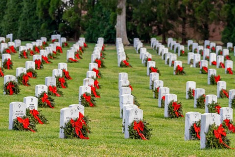 Atop a hill, a veterans cemetery with white headstones and the American flag evokes deep honour,