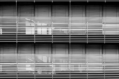 The modern façade of a chemical building and laboratory with highly light-reflecting metal blinds