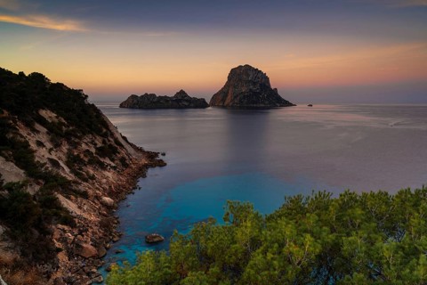A view of the landmark Es Vedra island and rocks off the coast of Ibiza at sunrise
