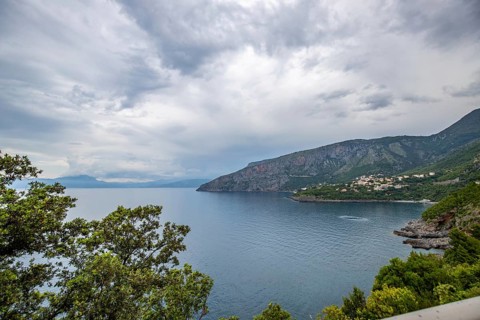 Coastal landscape shot. View from a road leading along the sea and through a breathtaking green